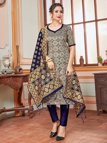 Here Is A Rich And Elegant Looking Silk Based Straight Suit In Dark Grey Colored Top Paired With Contrasting Navy Blue Colored Bottom And Dupatta. Its Top, Bottom And Dupatta Are Fabricated On Banarasi Silk Beautified With Heavy Detailed Weave.