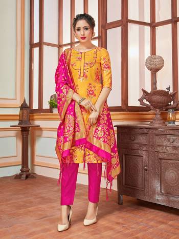 Here Is A Rich And Elegant Looking Silk Based Straight Suit In Musturd Yellow Colored Top Paired With Contrasting Rani Pink Colored Bottom And Dupatta. Its Top, Bottom And Dupatta Are Fabricated On Banarasi Silk Beautified With Heavy Detailed Weave.