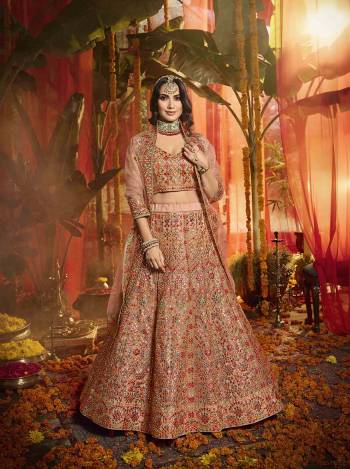 Get Ready For The Upcoming Wedding Season With This Very Beautiful Heavy Designer Lehenga Choli In Peach Color. This Lehenga Choli Is Fabricated On Orgenza Beautified With Lovely Embroidery Paired With Net Fabricated Dupatta. Buy Now.