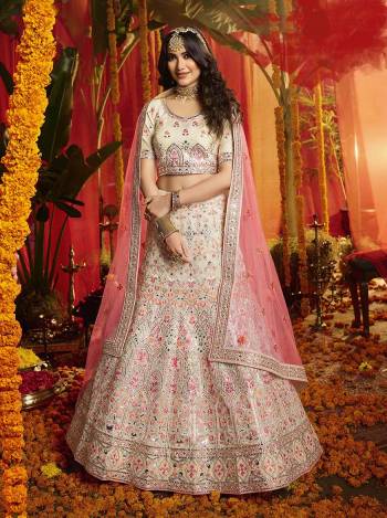 Here Is A Very Beautiful Heavy Embroidered Designer Lehenga Choli In Off-White Color Paired With Contrasting Pink Colored Dupatta. Its Lovely Blouse and Lehenga are Fabricated On Orgenza Paired With  Net Fabricated Dupatta. Its Pretty Color Pallete And Attractive Embroidery Will Earn You Lots Of Compliments From Onlookers. 