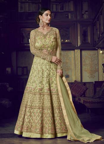 Flaunt Your Rich And Elegant Taste Wearing This Designer Semi-Stitched Floor Length Gown In Light Green Color Paired With Light Green Colored Dupatta. This Pretty Gown And Dupatta Are Fabricated On Net Beautified With Pretty Embroidery Giving An Attractive Look. 