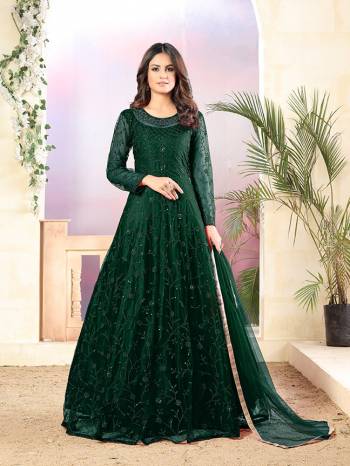 Grab This Very Beautiful Heavy Designer Floor Length Suit In Dark Green Color. Its Top Is Fabricated On Net Paired With Santoon Bottom and Net Fabricated Dupatta. It Is Beautified With Tone To Tone Embroidery All Over. Buy Now.