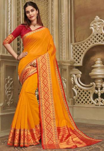 For A Decent And Formal Look, Grab This Pretty Elegant Looking Saree In Orange Color Paired With Contrasting Red Colored Blouse. This Saree And Blouse Are Fabricated On Khadi Silk Beautified With Broad Weaved Border. 