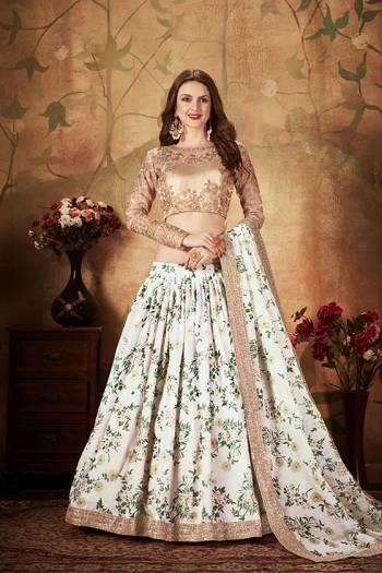 Get Ready For The Upcoming Wedding Season With This Beautiful Designer Lehenga Choli In Beige Colored Blouse Paired with Contrasting White Colored Lehenga And Dupatta. Its Pretty Embroidred Blouse Is Fabricated On Orgenza Paired with Orgenza Fabricated Printed Lehenga and Dupatta. 