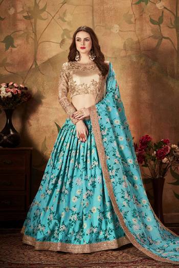 You Will Definitely Earn Lots Of Compliments Wearing This Orgenza Based Designer Lehenga Choli In Beige Colored Blouse Paired With Contrasting Blue Colored Lehenga and Dupatta. Its Blouse Is Orgenza Based Beautified With Embroidery Paired With Orgenza Fabricated Lehenga And Dupatta Beautified With Prints.