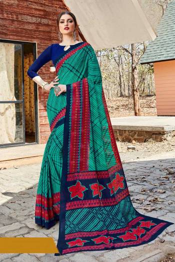 Simple And Elegant Looking Saree Is Here For Daily Wear In Sea Green color paired with Navy Blue Colored Blouse. This Saree And Blouse Are Georgette Based Which IS Light Weight And Ensures Superb Comfort All Day Long. 