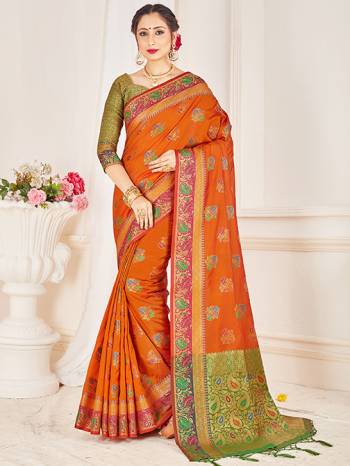 Here Is A Proper Traditional Looking Designer Silk Based saree In Rust Orange Color Paired With Green Colored Blouse. This Saree and Blouse AreFabricated On Banarasi Art Silk Beautified With Attractive Weave. 