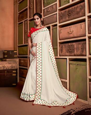 Define the best on indian culture in this classic combination of white and red saree infused with just the right amount of green hue. Style it with bold jewelry or go subtle with dainty ones, this design is at its versatile best. 