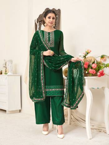 Here Is A Very Pretty Designer Straight Suit In All Over Dark Green Color. Its Beautiful Embroidered Top And Dupatta Are Georgette Based Paired With Santoon Bottom. Buy This Pretty Suit Now.