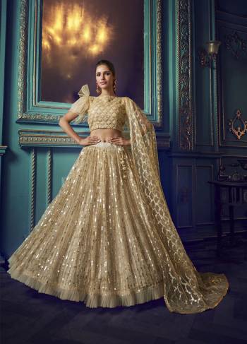 Here Is A Very Pretty Heavy Designer Lehenga Choli In Beige Color. Its Pretty Heavy Embroidered Lehenga, Choli And Dupatta Are Fabricated On Net. Its Fabric, Color And Embroidery Will Earn You Lots Of Compliments From Onlookers. 