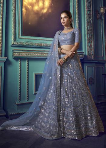 Here Is A Very Pretty Heavy Designer Lehenga Choli In Powder Blue Color. Its Pretty Heavy Embroidered Lehenga, Choli And Dupatta Are Fabricated On Net. Its Fabric, Color And Embroidery Will Earn You Lots Of Compliments From Onlookers. 