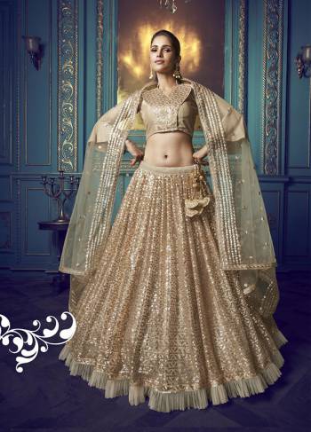 Here Is A Very Pretty Heavy Designer Lehenga Choli In Beige Color. Its Pretty Heavy Embroidered Lehenga, Choli And Dupatta Are Fabricated On Net. Its Fabric, Color And Embroidery Will Earn You Lots Of Compliments From Onlookers. 