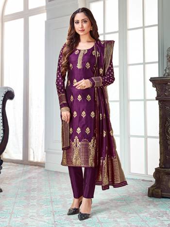 Here Is A Rich And Elegant Looking Silk Based Straight Suit In Purple Color. Its Top And Dupatta Are Fabricated On Banarasi Silk Paired with Art Silk Bottom. 