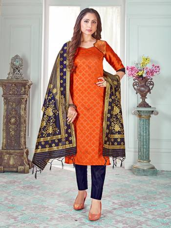 Here Is A Rich And Elegant Looking Silk Based Straight Suit In Orange Colored Top Paired With Navy Blue Colored Bottom And Dupatta. Its Top And Dupatta Are Fabricated On Banarasi Silk Paired with Art Silk Bottom. 