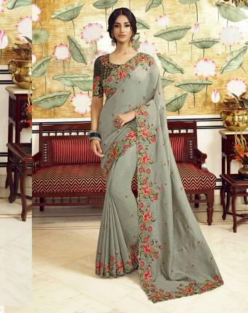 Flaunt Your Rich And Elegant Taste Wearing This Pretty Designer Saree In Grey Color Paired With Dark Green Colored Blouse. This Saree Is Fabricated On Vichitra Silk Paired With Art Silk Fabricated Blouse. It Is Beautified With Attractive Detailed Embroidery.  