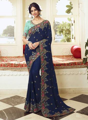 Look Attractive Wearing This Designer Saree In Navy Blue Color Paired with Sky Blue Colored blouse. This Saree Is Fabricated On Vichitra Silk Paired With Art Silk Fabricated Blouse. Its Pretty Embroidery, Colors And Rich Fabric Will Earn You Lots Of Compliments From Onlookers. 