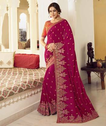 Flaunt Your Rich And Elegant Taste Wearing This Pretty Designer Saree In Dark Pink Color Paired With Orange Colored Blouse. This Saree Is Fabricated On Vichitra Silk Paired With Art Silk Fabricated Blouse. It Is Beautified With Attractive Detailed Embroidery.  