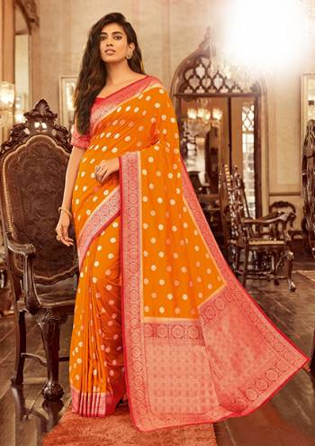 Celebrate This Festive Season Wearing This Pretty Designer Silk Based Saree In Orange Color Paired With Red Colored Blouse. This Saree And Blouse Are Fabricated On Chanderi Cotton Beautified With Weave All Over. 