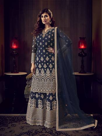 Get Ready For The Upcoming Wedding And Festive Season Wearing This Heavy Designer Sharara Suit In Navy Blue Color. This Sharara Suit In Fabricated On Net Beautified With Heavy Detailed Embroidery Giving An Attractive Look. 