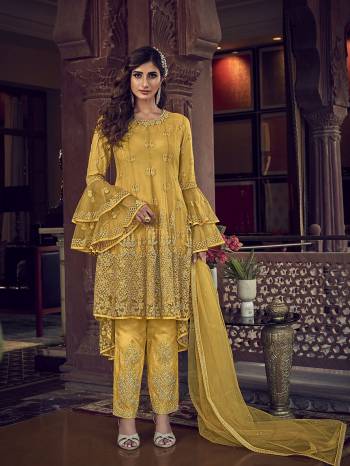 Add This Very Beautiful Heavy Designer Suit To Your Wardrobe In All Over Yellow Color. Its Embroidered Top, Bottom and Dupatta Are Fabricated On Net Which Is Light In Weight and Easy To Carry Throughtout The Gala. 