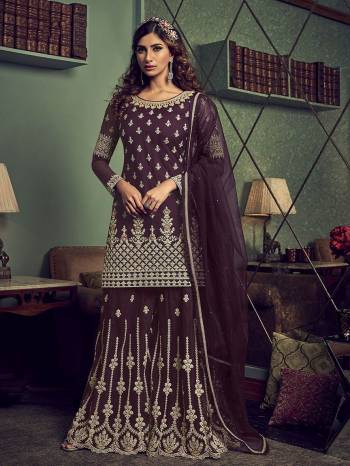 Get Ready For The Upcoming Wedding And Festive Season Wearing This Heavy Designer Sharara Suit In Wine Color. This Sharara Suit In Fabricated On Net Beautified With Heavy Detailed Embroidery Giving An Attractive Look. 