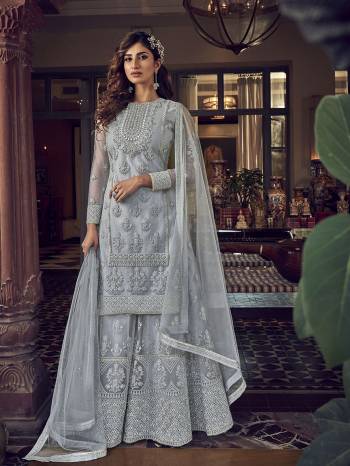 Add This Very Beautiful Heavy Designer Suit To Your Wardrobe In All Over Grey Color. Its Embroidered Top, Bottom and Dupatta Are Fabricated On Net Which Is Light In Weight and Easy To Carry Throughtout The Gala. 