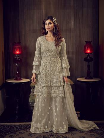 Look Pretty In This Heavy Designer Shararar Suit In Sand Grey Color. Its Beautiful Top, Bottom and Dupatta Are Fabricated On Net Beautified With Heavy Detailed Embroidery. Its Pretty Color And Embroidery Will Earn You Lots Of compliments From Onlookers. 