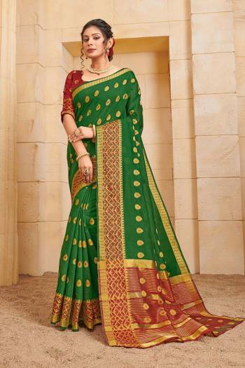 Celebrate This Festive Season Wearing This Lovely Weaved Designer Saree In Green Color Paired With Contrasting Maroon Colored Blouse. This Saree And Blouse Are Fabricated On Cotton Which Also Gives A Rich Look To Your Personality. 