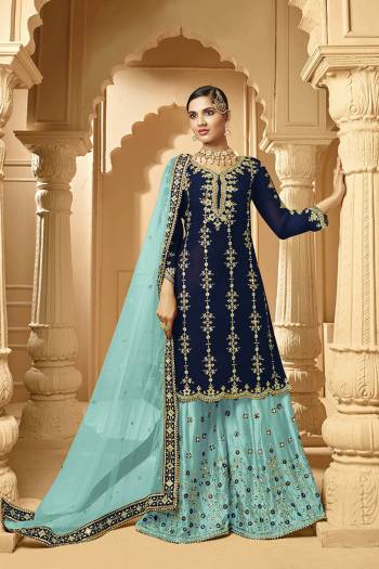 Here Is A Very Beautiful Designer Heavy Suit In Navy Blue Color Paired With Sky Blue Colored bottom And Dupatta. Its Embroidered Top And Bottom Are Georgette Based Paired with Net Fabricated Dupatta. 