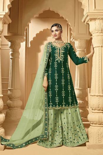 Here Is A Very Beautiful Designer Heavy Suit In Green Color Paired With Light Green Colored bottom And Dupatta. Its Embroidered Top And Bottom Are Georgette Based Paired with Net Fabricated Dupatta. 