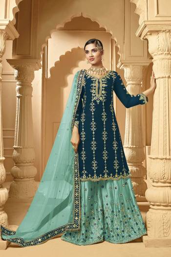 Here Is A Very Beautiful Designer Heavy Suit In Teal Blue Color Paired With Turqoise Blue Colored bottom And Dupatta. Its Embroidered Top And Bottom Are Georgette Based Paired with Net Fabricated Dupatta. 