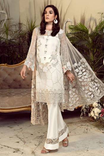 Grab This Pretty Heavy Embroidered Pakistani Designer Suit In White Color. Its Embroidered Top Is Georgette Based Paired With Santoon Bottom and Net Fabricated Embroidered Dupatta. 