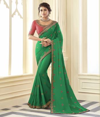 Grab This Very Pretty Designer Saree In Green Color Paired With Contrasting Pink Colored Blouse. This Saree Is Fabricated On Satin Silk Paired With Art Silk Fabricated Blouse. It Is Beautified With Detailed Embroidery Work Giving An Attractive Look. 