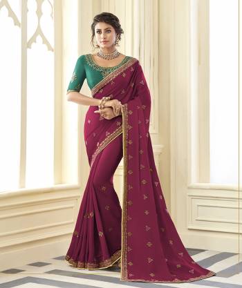 You Will Definitely Earn Lots Of Compliments Wearing This Designer Saree In Magenta Pink Color Paired With Contrasting Green Colored Blouse. This Embroidered Saree Is Satin Silk Based Paired With Art Silk Fabricated Blouse. Buy Now.