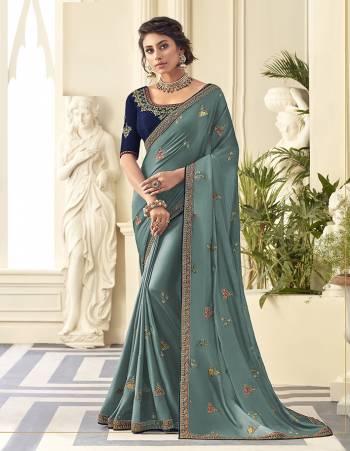 Grab This Very Pretty Designer Saree In Steel Blue Color Paired With Contrasting Navy Blue Colored Blouse. This Saree Is Fabricated On Satin Silk Paired With Art Silk Fabricated Blouse. It Is Beautified With Detailed Embroidery Work Giving An Attractive Look. 