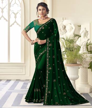 Get Ready For the Upcoming Wedding And Festive Season Wearing This Beautiful Designer Embroidered Saree In Dark Green Color Paired With Contrasting Green colored Blouse. This Saree Is Fabricated On Satin Silk Paired With Art Silk Fabricated Blouse. Its Rich Fabric And Color Will Earn You Lots Of Compliments From Onlookers. 