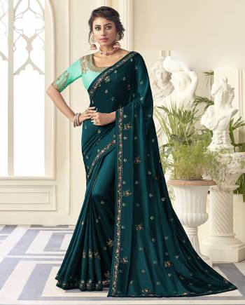 Grab This Very Pretty Designer Saree In Teal Blue Color Paired With Contrasting Turquoise Blue Colored Blouse. This Saree Is Fabricated On Satin Silk Paired With Art Silk Fabricated Blouse. It Is Beautified With Detailed Embroidery Work Giving An Attractive Look. 