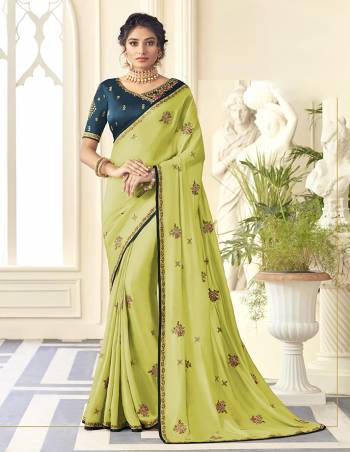 You Will Definitely Earn Lots Of Compliments Wearing This Designer Saree In Light Green Color Paired With Contrasting Teal Blue Colored Blouse. This Embroidered Saree Is Satin Silk Based Paired With Art Silk Fabricated Blouse. Buy Now.