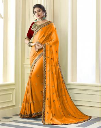 Get Ready For the Upcoming Wedding And Festive Season Wearing This Beautiful Designer Embroidered Saree In Musturd Yellow Paired With Contrasting Red colored Blouse. This Saree Is Fabricated On Satin Silk Paired With Art Silk Fabricated Blouse. Its Rich Fabric And Color Will Earn You Lots Of Compliments From Onlookers. 