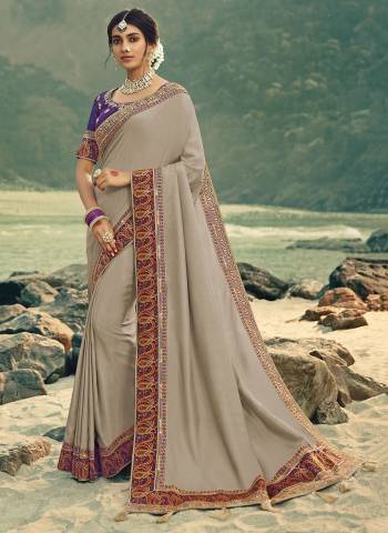 Flaunt Your Rich and Elegant Taste Wearing This Designer Saree In Grey Color Paired With Purple Colored Blouse. This Saree Is Fabricated On Vichitra Silk Paired With Art Silk Fabricated Blouse. Its Rich Fabric And Color Will Earn You Lots Of Compliments From Onlookers. 