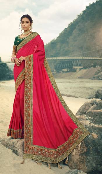 Here Is A Beautiful Designer Saree In Rani Pink Color Paired With Contrasting Dark Green Colored Blouse. This Saree Is Fabricated On Vichitra Silk With Jacquard Silk Border Paired With Art Silk Fabricated Blouse. This Pretty Saree Is Easy To Drape And Carry All Day Long. Buy Now.