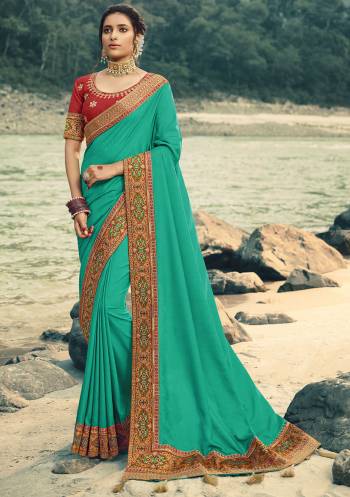 Adorn The Pretty Aneglic Look Wearing This Beautiful Attractive Designer Saree In Sea Green Color Paired With Red Colored blouse. This Saree Is Fabricated On Vichitra Silk Paired With Art Silk Fabricated Blouse. It Is Beautified With Jacquard Silk Colorful Border. 