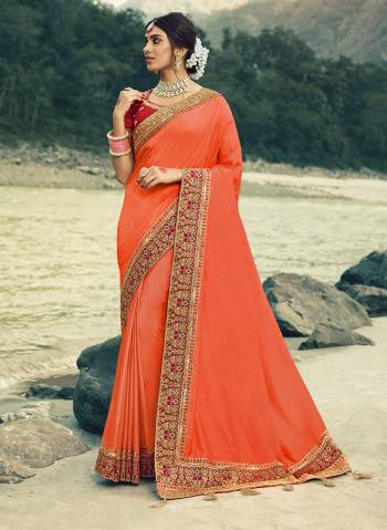 Here Is A Beautiful Designer Saree In Orange Color Paired With Contrasting Red Colored Blouse. This Saree Is Fabricated On Vichitra Silk With Jacquard Silk Border Paired With Art Silk Fabricated Blouse. This Pretty Saree Is Easy To Drape And Carry All Day Long. Buy Now.