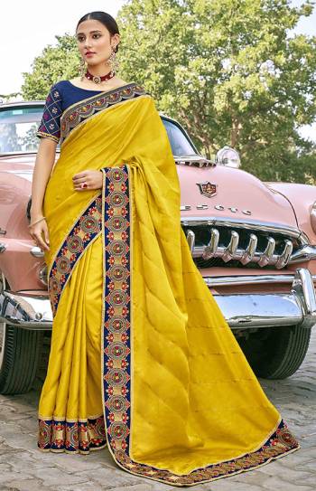 Celebrate This Festive Season In This Very Pretty Yellow Colored Designer Saree Paired With Contrasting Navy Blue Colored Blouse. This Saree and Blouse Are Silk Based Beautified With Detailed Embroidery. 