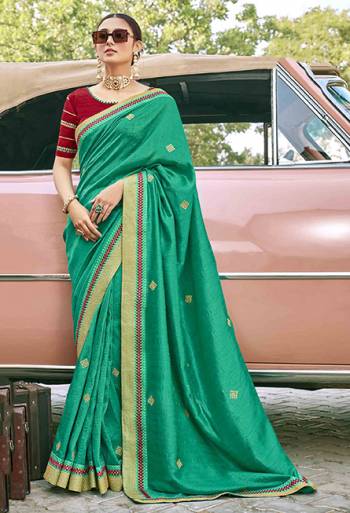 Grab This Pretty Elegant Looking Designer Saree In Green Color Paired With Contrasting Red Colored Blouse. This Saree And Blouse Are Silk Based Beautified With Embroidery. Buy Now.