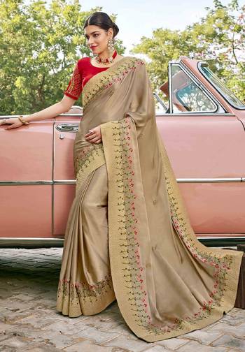 Adorn The Pretty Angelic Look Wearing This Heavy Designer Saree In BeigeColor Paired With Contrasting Red Colored Blouse. This Saree Is Fabricated On Satin Silk Paired With Art Silk Fabricated Blouse. Its Pretty Color Pallete Will Give An Attractive Look To Your Personality. 