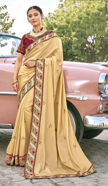 Adorn The Pretty Angelic Look Wearing This Heavy Designer Saree In Beige Color Paired With Contrasting Maroon Colored Blouse. This Saree Is Fabricated On Satin Silk Paired With Art Silk Fabricated Blouse. Its Pretty Color Pallete Will Give An Attractive Look To Your Personality. 