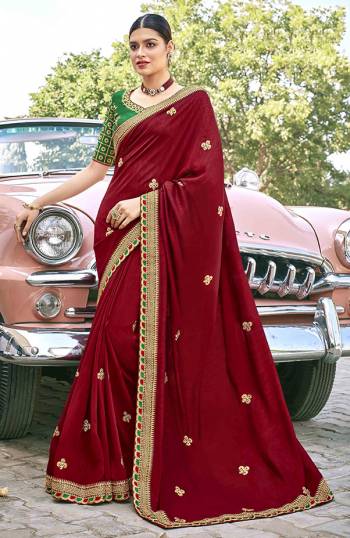 Celebrate This Festive Season In This Very Pretty Maroon Colored Designer Saree Paired With Contrasting Green Colored Blouse. This Saree and Blouse Are Silk Based Beautified With Detailed Embroidery. 